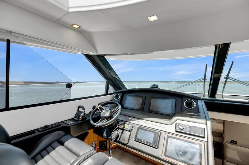  Yacht Photos Pics Interior view of 2020 Riviera 4800 Sport Yacht helm with modern navigation equipment.