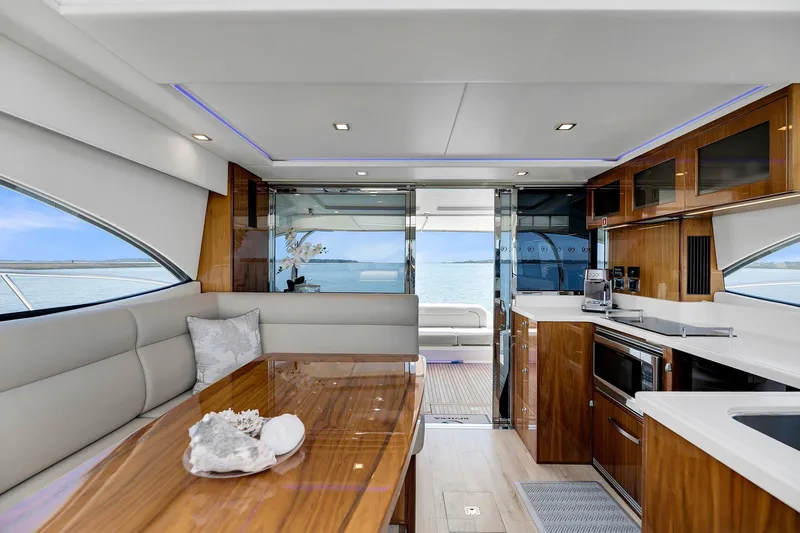  Yacht Photos Pics Luxurious interior of 2020 Riviera 4800 Sport Yacht with modern kitchen and ocean view.