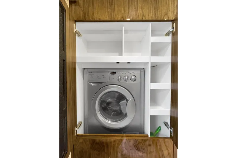  Yacht Photos Pics Washing machine in wooden cabinet on 2020 Riviera 4800 Sport Yacht.