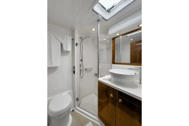  Yacht Photos Pics Luxurious bathroom in 2020 Riviera 4800 Sport Yacht with modern fixtures and elegant design.