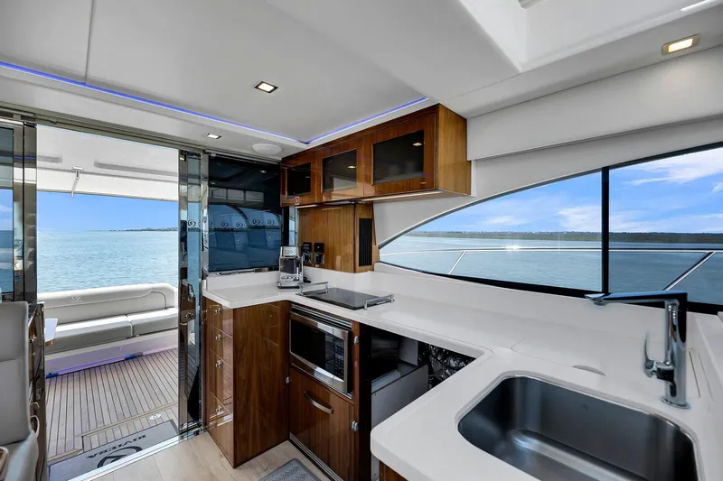  Yacht Photos Pics Luxurious interior of 2020 Riviera 4800 Sport Yacht with modern kitchen and ocean view.