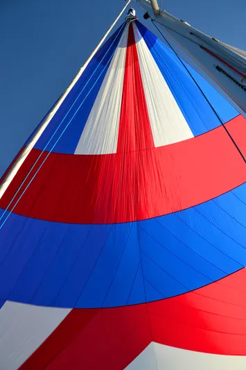 Bonejour Yacht Photos Pics Colorful sail of a 2012 Hanse 385 yacht against a clear blue sky.