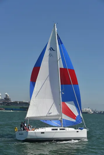 Bonejour Yacht Photos Pics Sailing yacht Hanse 385, 2012 model, with colorful spinnaker on open water.