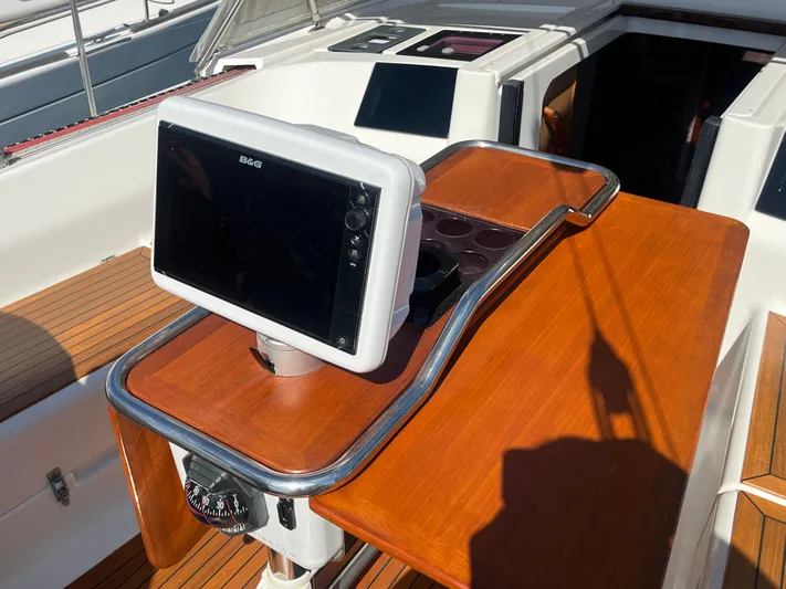 Bonejour Yacht Photos Pics Hanse 385 yacht cockpit with navigation system, 2012 model, featuring wooden and metal finishes.