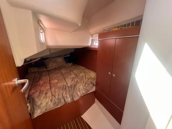 Bonejour Yacht Photos Pics Cozy cabin interior of 2012 Hanse 385 sailboat with bed and wooden cabinetry.