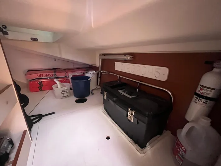 Bonejour Yacht Photos Pics Storage area in a 2012 Hanse 385 sailboat with life jackets, toolbox, and fire extinguisher.