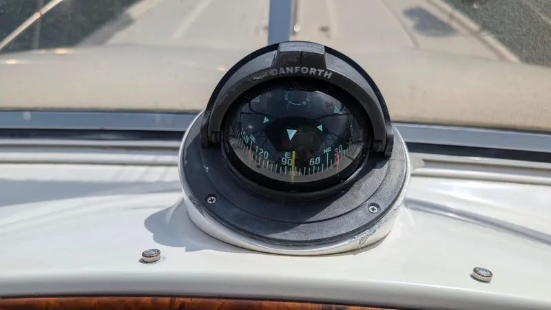 Anna Leeza Yacht Photos Pics Compass on 2004 Meridian 408 Motor Yacht dashboard, displaying navigation directions.