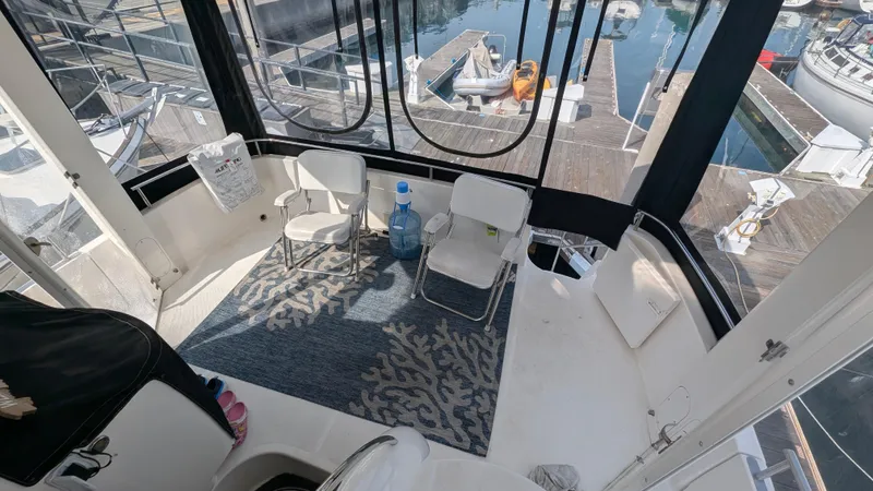 Anna Leeza Yacht Photos Pics 2004 Meridian 408 Motor Yacht interior with chairs, rug, and marina view.