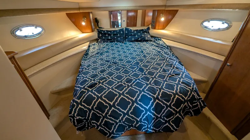 Anna Leeza Yacht Photos Pics Luxurious bedroom in 2004 Meridian 408 Motor Yacht with patterned bedding and ambient lighting.