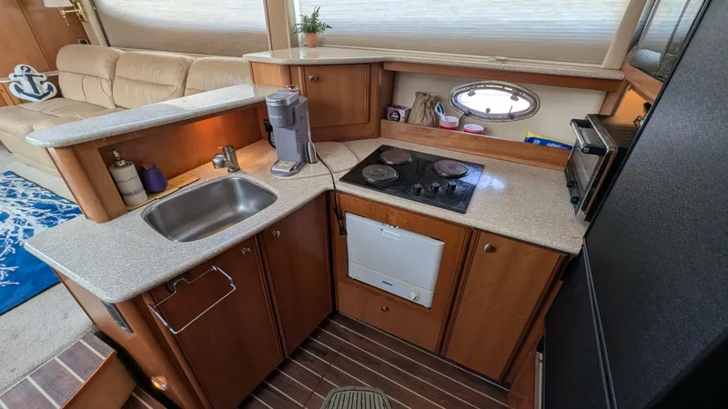 Anna Leeza Yacht Photos Pics 2004 Meridian 408 Motor Yacht kitchen with sink, stove, and compact appliances.
