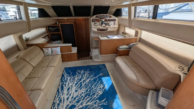 Anna Leeza Yacht Photos Pics Interior of 2004 Meridian 408 Motor Yacht with beige seating and blue rug.