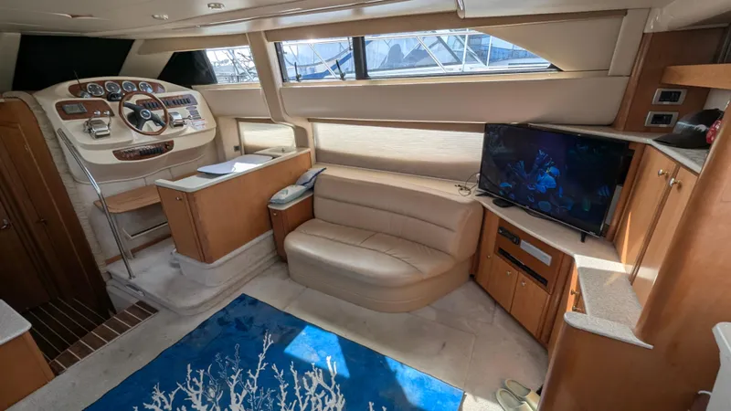 Anna Leeza Yacht Photos Pics Interior of 2004 Meridian 408 Motor Yacht with helm, seating, and TV.