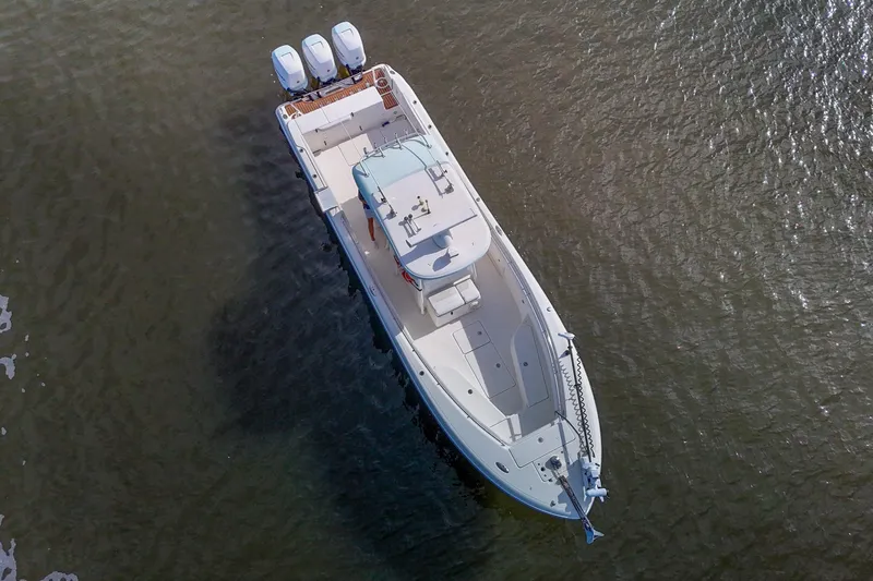  Yacht Photos Pics Aerial view of 2008 Triton 351 CC boat on water with triple engines.