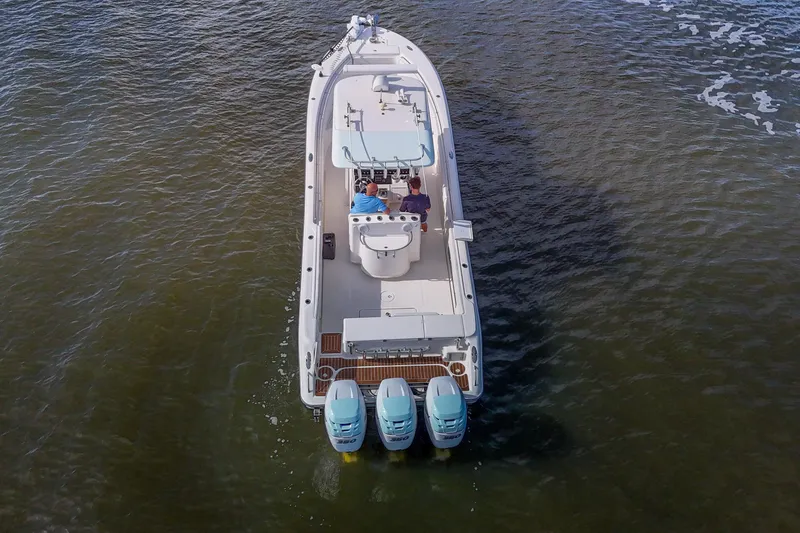  Yacht Photos Pics 2008 Triton 351 CC boat on water, aerial view, featuring triple outboard engines.