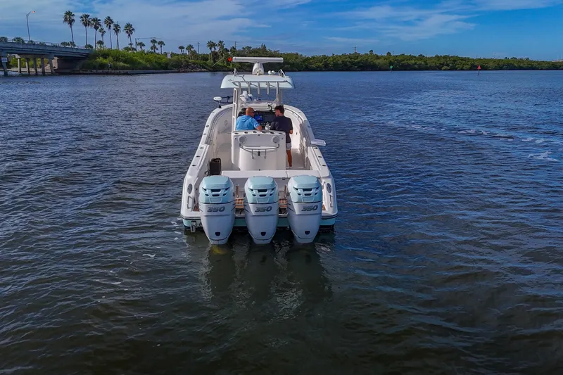  Yacht Photos Pics 2008 Triton 351 CC boat with triple engines cruising on a sunny day.