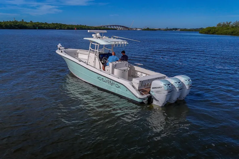  Yacht Photos Pics 2008 Triton 351 CC boat with triple Mercury engines on calm water.