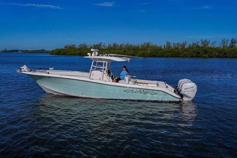  Yacht Photos Pics 2008 Triton 351 CC boat on calm water under clear blue sky.