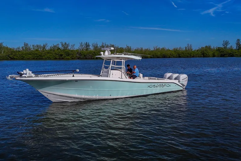  Yacht Photos Pics 2008 Triton 351 CC boat on calm water under clear blue sky.
