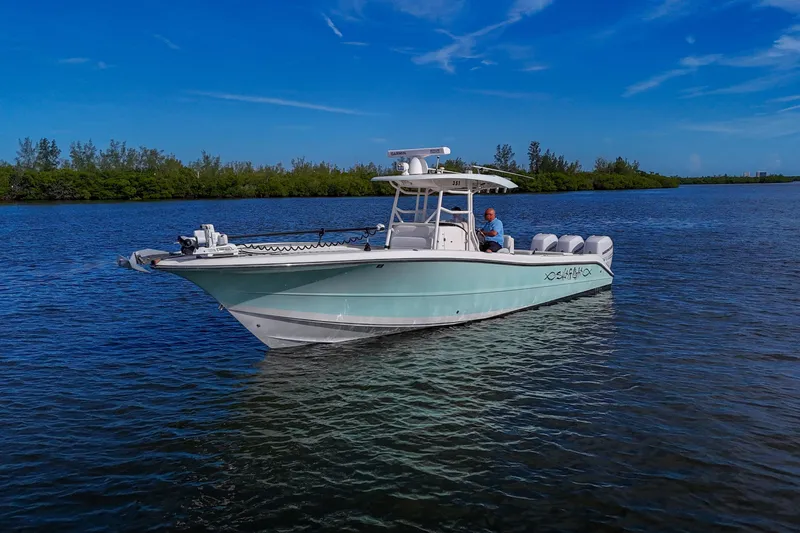  Yacht Photos Pics 2008 Triton 351 CC boat on calm water under clear blue sky.