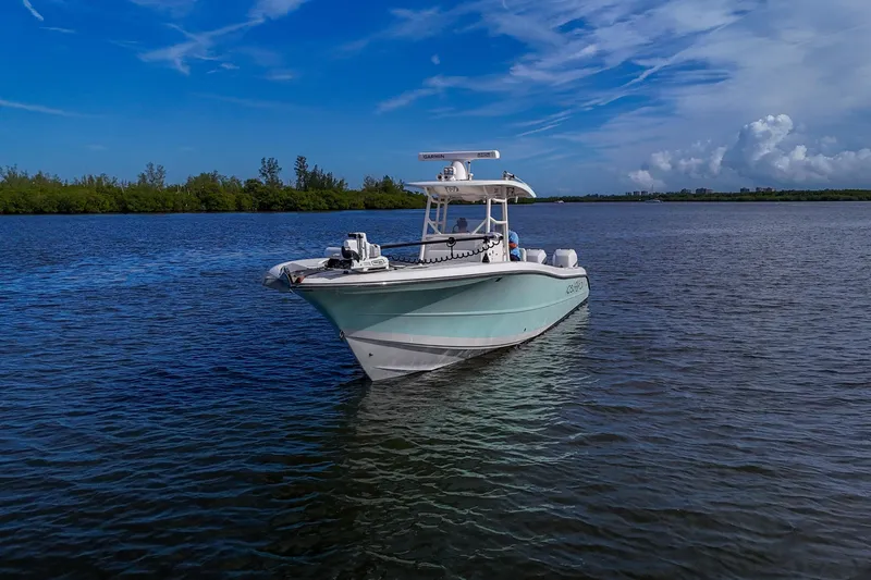  Yacht Photos Pics 2008 Triton 351 CC boat on calm water under a clear blue sky.