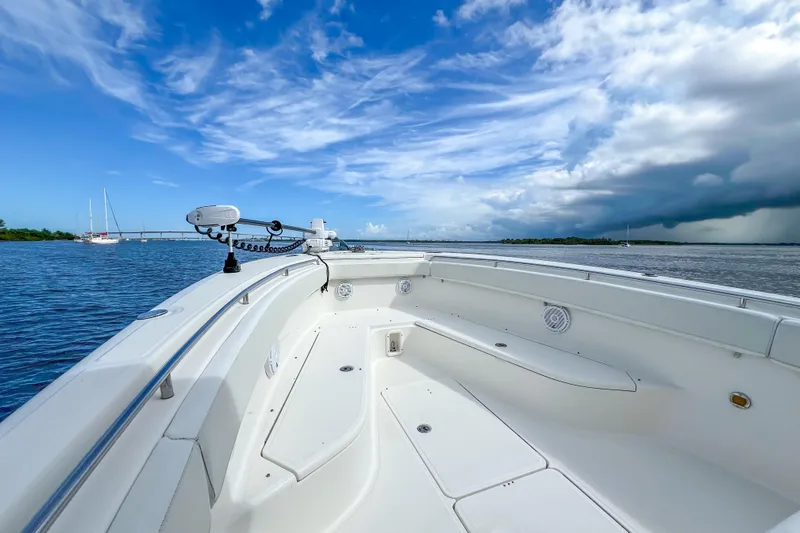  Yacht Photos Pics 2008 Triton 351 CC boat on calm waters under a partly cloudy sky.
