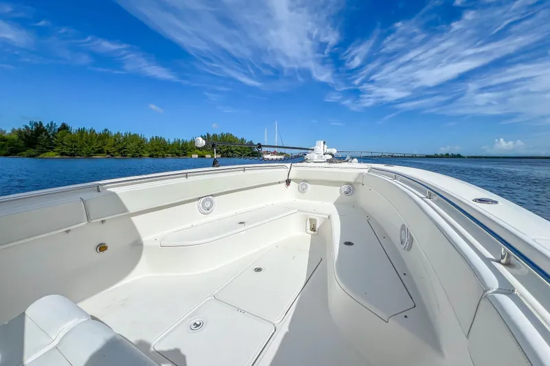  Yacht Photos Pics 2008 Triton 351 CC boat on calm water under a clear blue sky.
