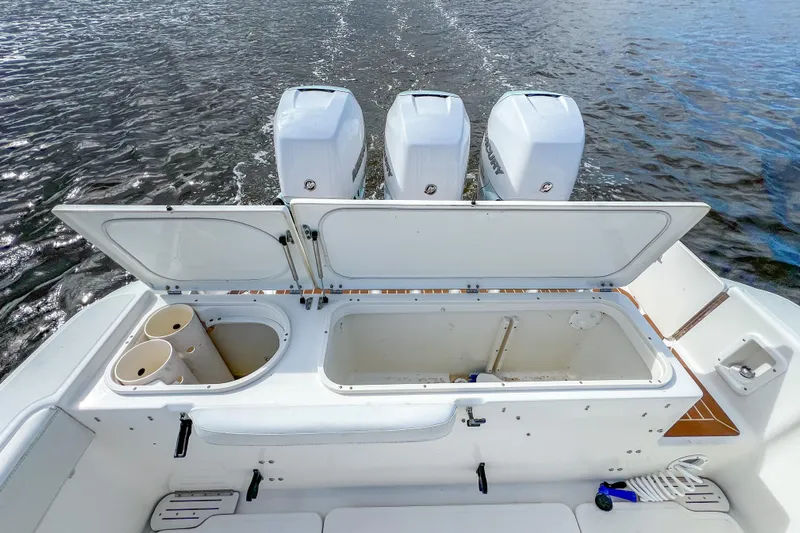  Yacht Photos Pics 2008 Triton 351 CC boat with open storage compartments and triple outboard engines.