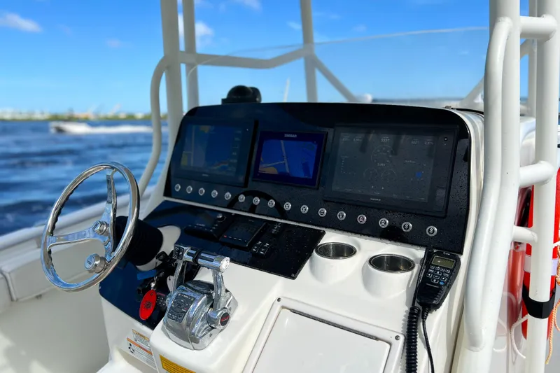  Yacht Photos Pics Cockpit of 2008 Triton 351 CC boat with navigation screens and steering wheel.