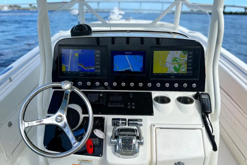  Yacht Photos Pics 2008 Triton 351 CC boat dashboard with navigation screens and steering wheel.