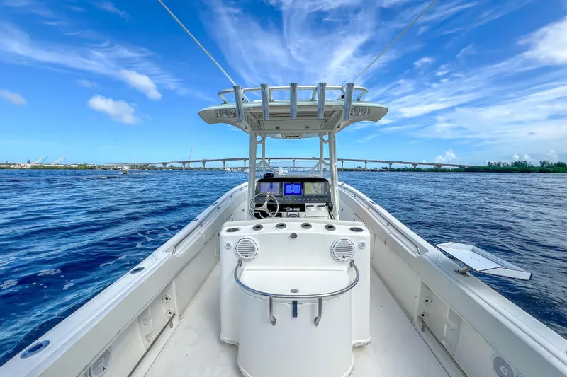  Yacht Photos Pics 2008 Triton 351 CC boat on open water under a clear blue sky.