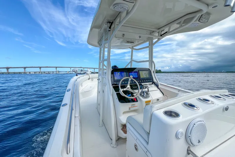  Yacht Photos Pics 2008 Triton 351 CC boat on water, featuring modern helm and clear blue sky.