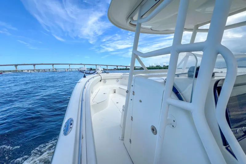  Yacht Photos Pics 2008 Triton 351 CC boat cruising on open water under a clear blue sky.