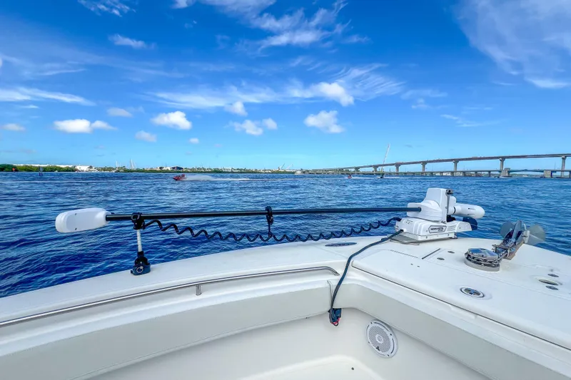  Yacht Photos Pics 2008 Triton 351 CC boat on water, bridge in background, clear blue sky.