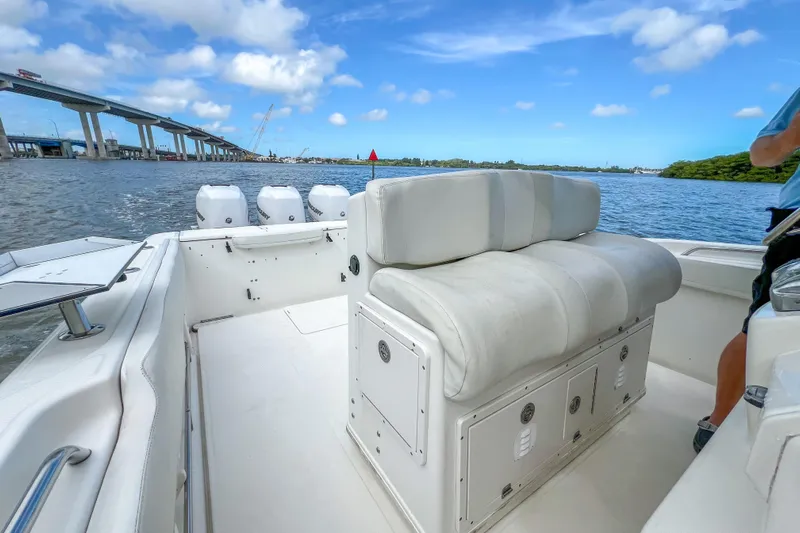  Yacht Photos Pics 2008 Triton 351 CC boat interior with seating, on a sunny day near a bridge.
