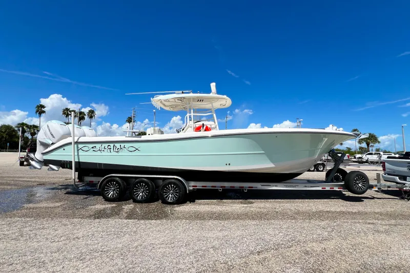  Yacht Photos Pics 2008 Triton 351 CC boat on trailer under clear blue sky.