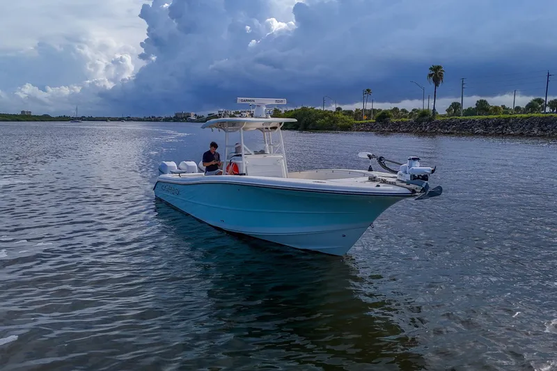  Yacht Photos Pics 2008 Triton 351 CC boat on water under cloudy sky, near shoreline.