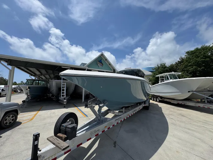  Yacht Photos Pics 2021 Fountain 38TE boat on trailer under blue sky.