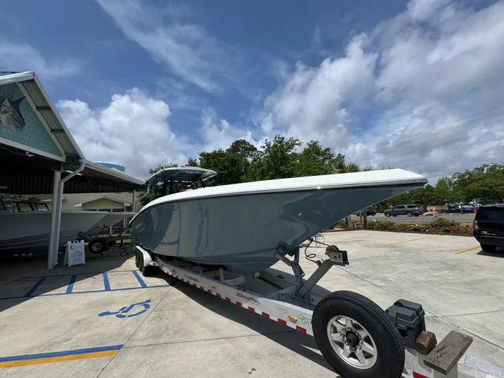  Yacht Photos Pics 2021 Fountain 38TE boat on trailer, parked outdoors under a cloudy sky.