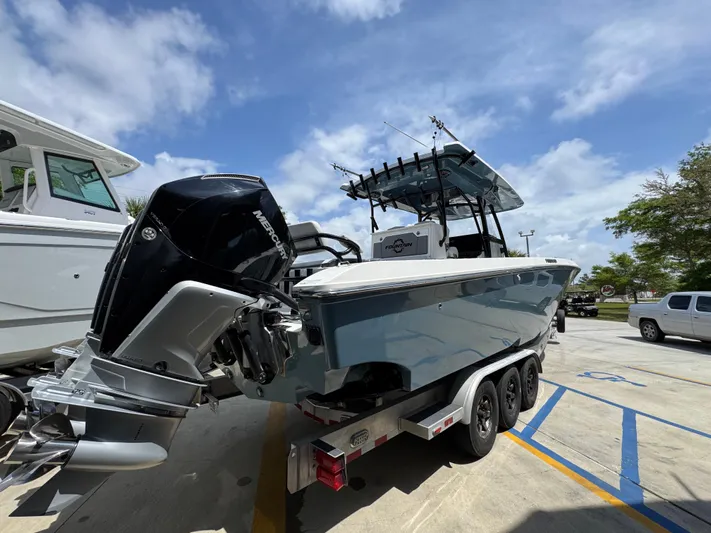  Yacht Photos Pics 2021 Fountain 38TE boat on trailer, parked outdoors under a partly cloudy sky.