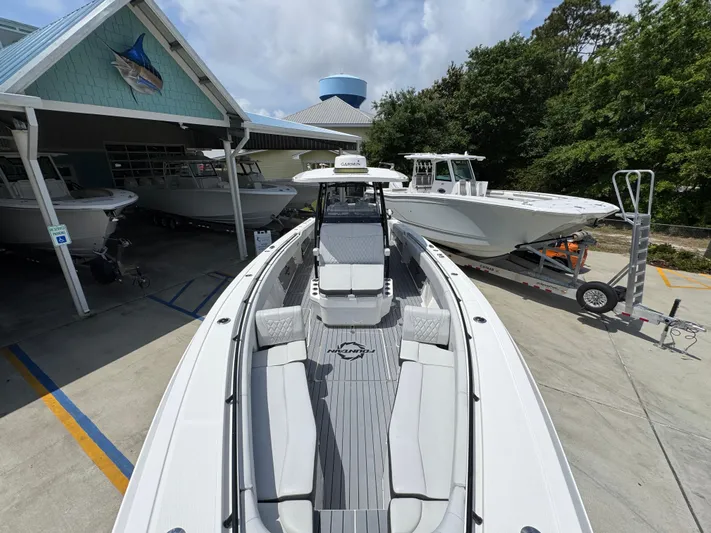  Yacht Photos Pics 2021 Fountain 38TE boat displayed at a marina with other boats.