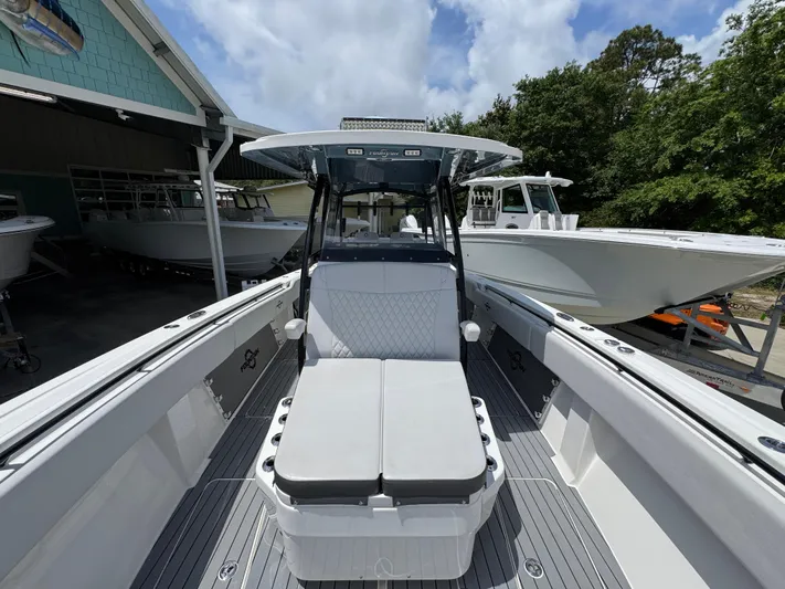  Yacht Photos Pics 2021 Fountain 38TE boat with sleek design, docked outdoors under a cloudy sky.