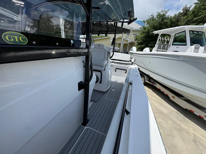  Yacht Photos Pics 2021 Fountain 38TE boat, sleek design, docked beside another vessel, sunny day.