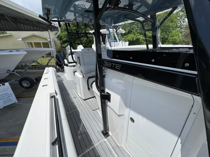  Yacht Photos Pics 2021 Fountain 38TE boat with sleek design and modern interior, docked outdoors.
