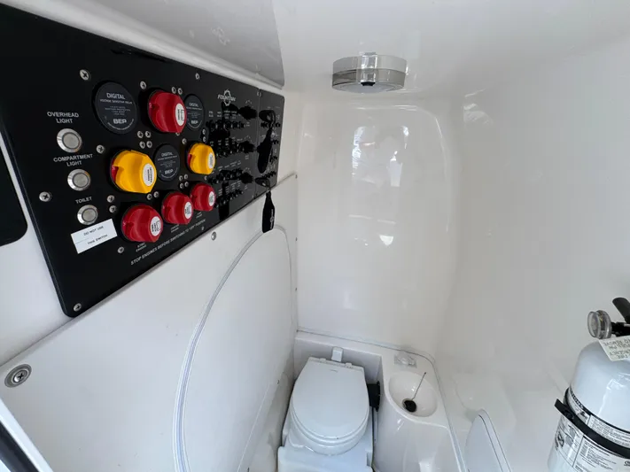  Yacht Photos Pics Interior of 2021 Fountain 38TE boat with control panel and compact toilet.