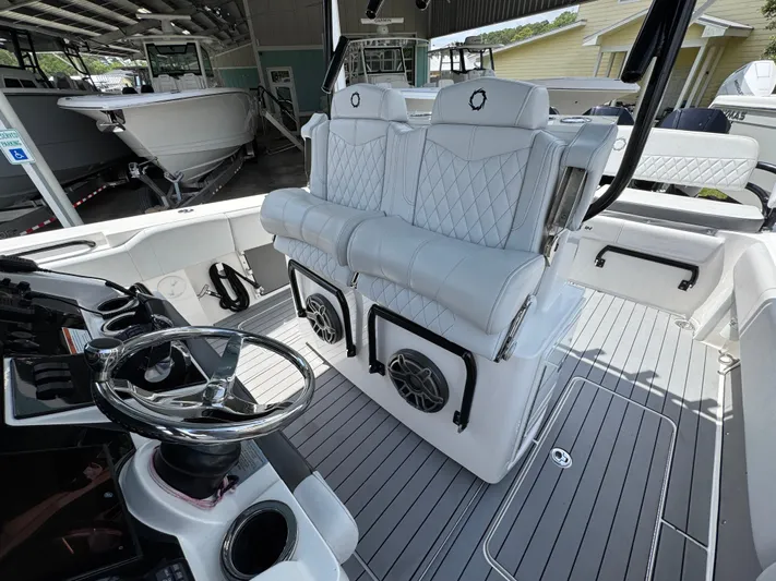  Yacht Photos Pics Luxurious 2021 Fountain 38TE boat interior with plush seating and modern steering wheel.