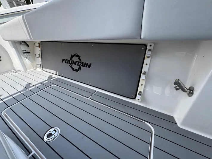  Yacht Photos Pics 2021 Fountain 38TE boat deck with logo, featuring sleek gray flooring.