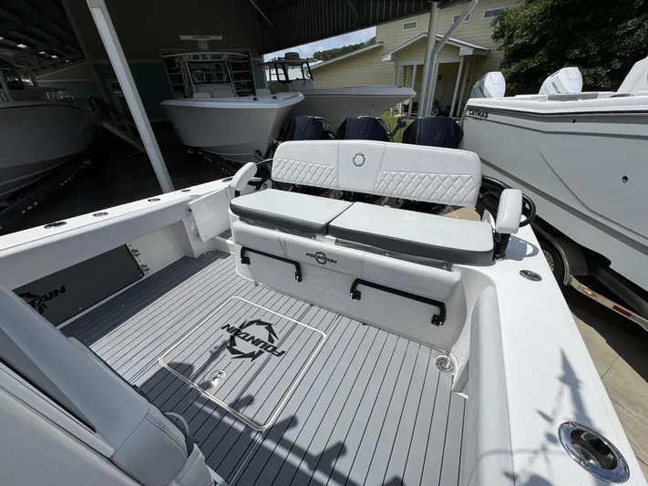  Yacht Photos Pics 2021 Fountain 38TE boat interior with cushioned seating and sleek deck design.