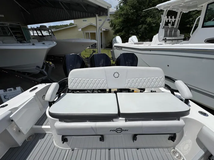  Yacht Photos Pics 2021 Fountain 38TE boat with cushioned seating and multiple outboard engines in a marina.