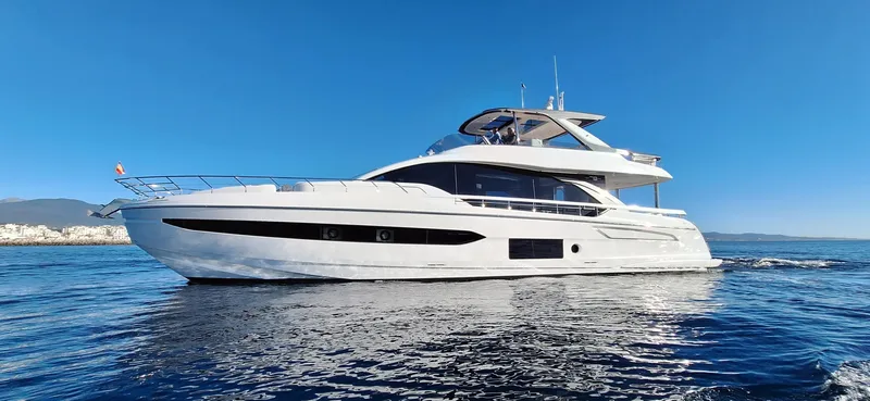 Nassara Yacht Photos Pics 2023 Azimut 78 yacht cruising on clear blue water under a bright sky.