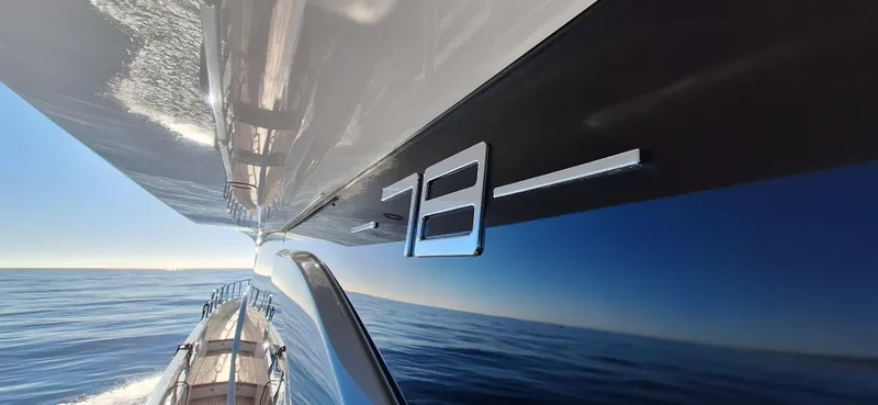 Nassara Yacht Photos Pics 2023 Azimut 78 yacht cruising on open sea, sleek design reflecting sunlight.